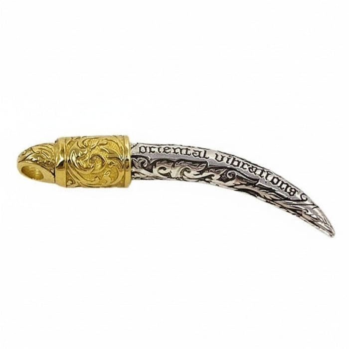 The back of the silver tusk pendant showing the intricate handcrafted floral carvings.