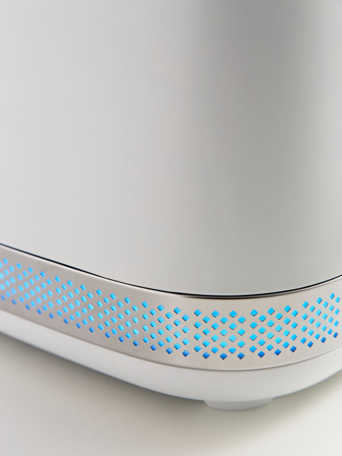Close-up of a white electronic device with blue LED lights