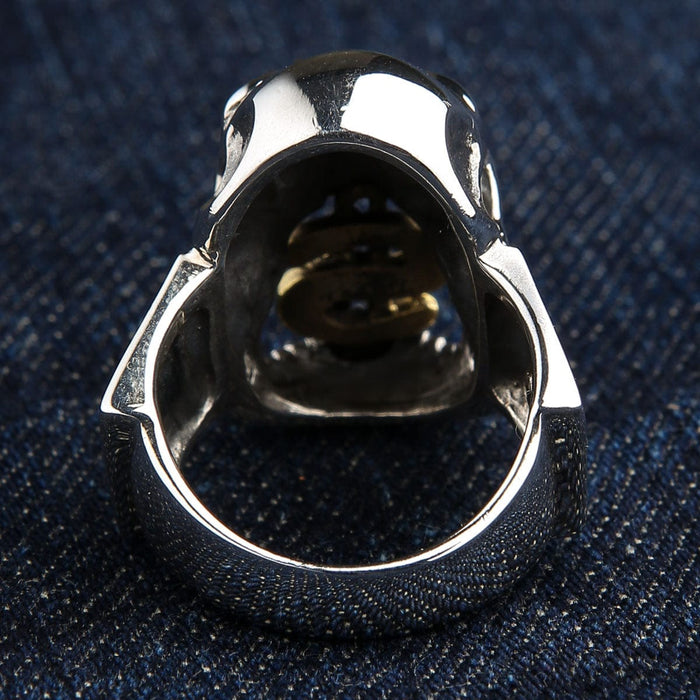 The inside of the heavy silver dollar sign skull ring.