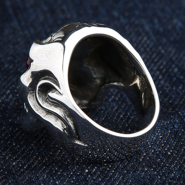 Bottom view revealing the hollowed interior and smooth polished inner shank of the silver ring resting on dark denim.