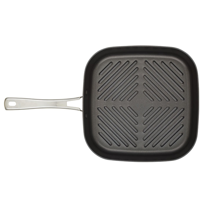 The 11-Inch Cook + Create Hard Anodized Nonstick Deep Grill Pan, designed with a square shape and metal handle, features a durable ridged cooking surface crafted from hard anodized aluminum.