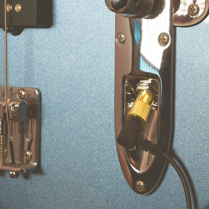 Gold 1/4" Adapter plugged into guitar