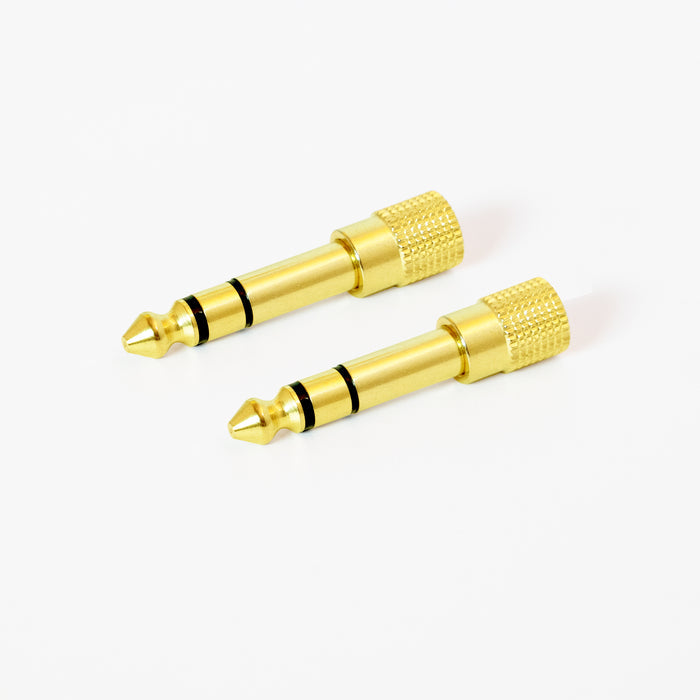 2 Gold-plated 1/4 inch Stereo audio adapters with a knurled grip on a white background