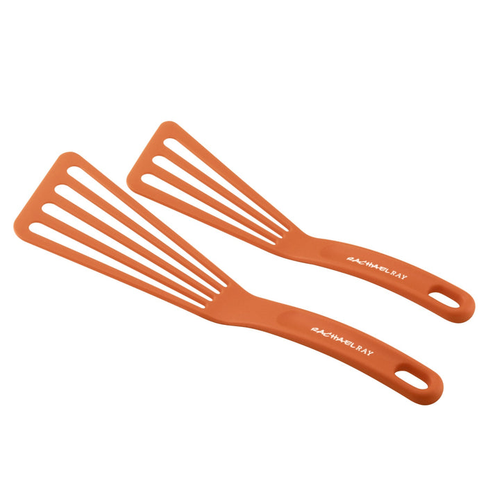 The 4-Piece Nonstick Sheet Pan and Turner Set includes two orange kitchen spatulas with slotted heads and brand text on the handles, perfect for any culinary task. These spatulas are dishwasher-safe, ensuring effortless cleanup after use with your nonstick baking pans.