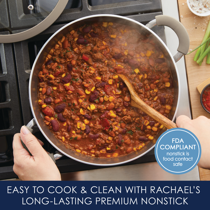 A hearty pot of chili with corn and beans simmers on the stove in the 5-Quart Cook + Create Nonstick Dutch Oven with Lid, offering an easy-clean cooking surface and a wooden spoon nestled inside. It's perfect for those interested in exploring stove-to-oven recipes.