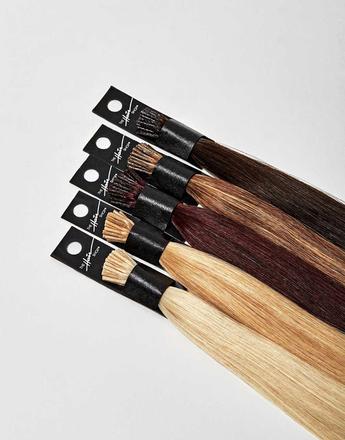 row of  bundles of I-tip extensions in a variety of colors