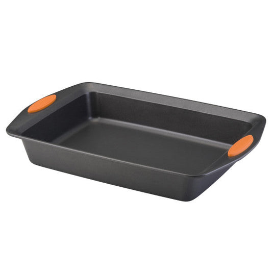 The 9-Inch x 13-Inch Nonstick Rectangle Roasting & Cake Pan includes vibrant orange handle grips on each side and is made from heavy gauge steel for durability and oven safety.