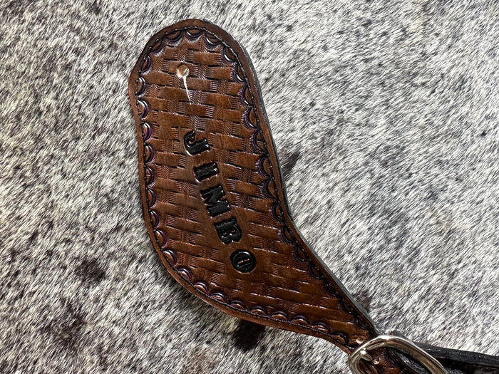 Hand tooled and painted basket weave spur straps.