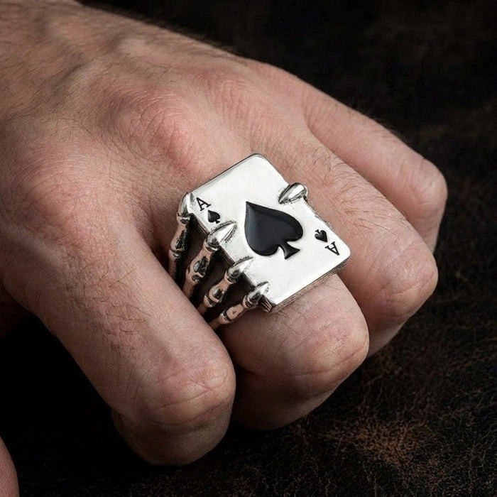 Ace of Spades sterling silver ring with skeleton hand design worn on man's finger showing substantial size