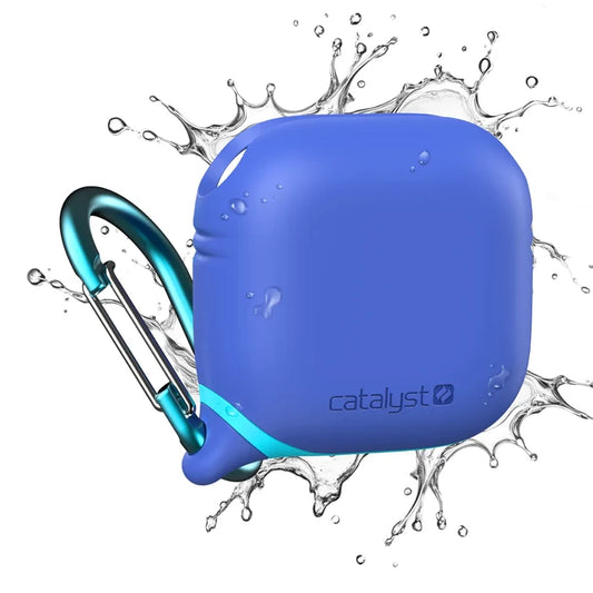 An Indigo Blue Catalyst Case US AirPods (Gen 4) Waterproof Case is shown with a metal carabiner attached as water splashes around, highlighting its waterproof design. The Catalyst logo appears on the lower right corner of the case.