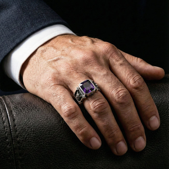 Man wearing a large square amethyst silver ring on the ring finger with a business suit, showing sophisticated style.