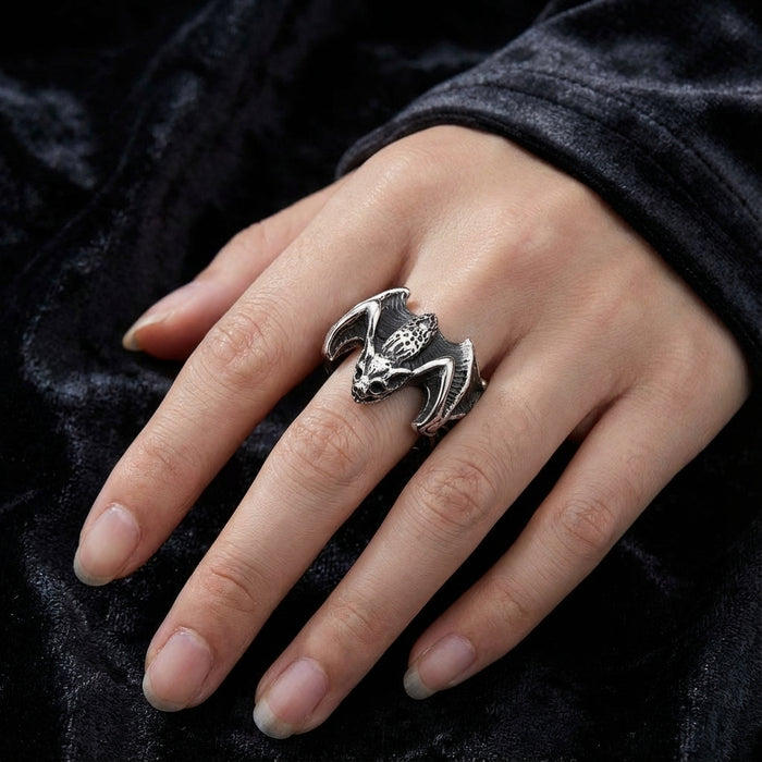 A model's hand wearing the sterling silver gothic bat ring to clearly show its scale and bold design.