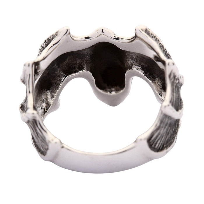 Underside of the bat ring showing the hollowed, oxidized cavity beneath the wings and the polished inner band.