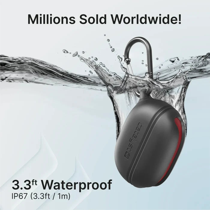 A black, oval Catalyst Case US silicone case for Beats Studio Buds/Plus with carabiner is shown splashed with water. Text reads, "Millions Sold Worldwide!" and "3.3 ft Waterproof, IP67." Light background with flowing water.