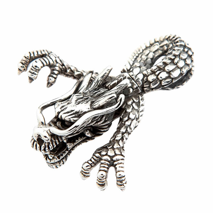 Angled profile of the oxidized silver dragon pendant, highlighting the open jaw, fangs, and textured ridges along the skull.