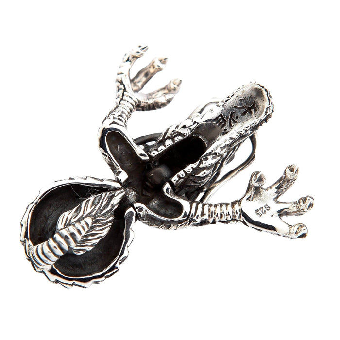 Reverse side of the silver dragon pendant displaying the hollowed interior and a 925 hallmark stamped on the claw.