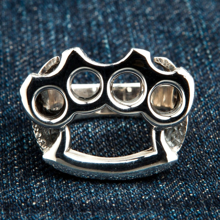 Front view of polished sterling silver knuckle duster ring showing four finger holes