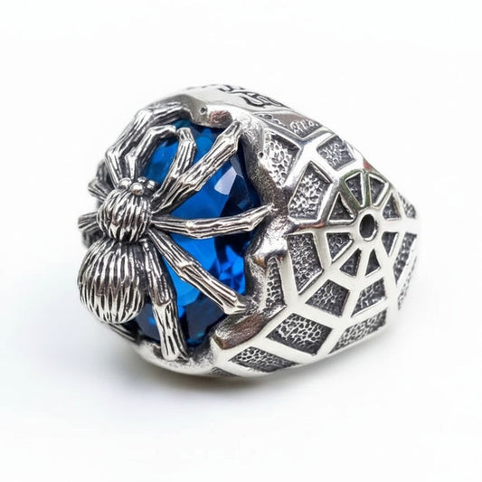 A side profile of the men's gothic spider ring, showing the 3D silver spider, blue CZ stone, and the intricate spider web band design.