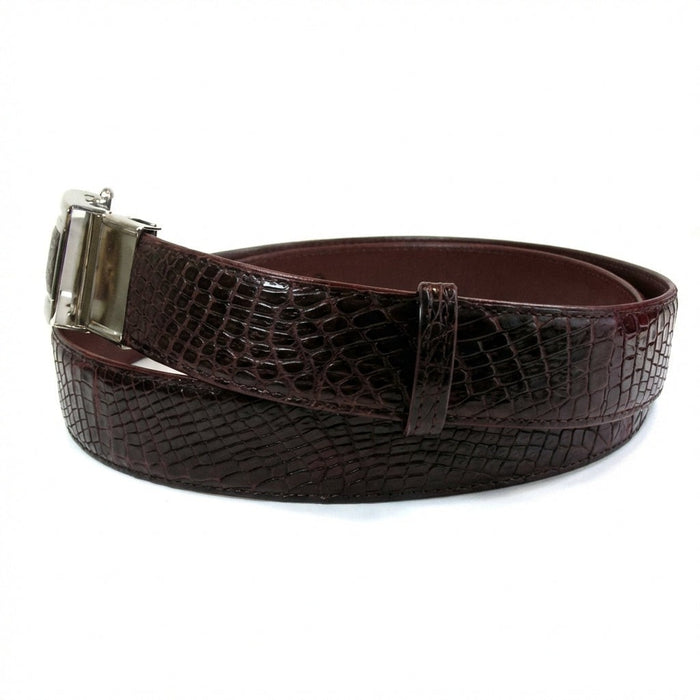 Handcrafted burgundy crocodile skin belt coiled showing scale pattern