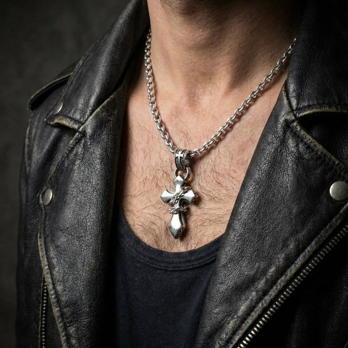 Man wearing sterling silver chained cross pendant with silver chain and black leather jacket