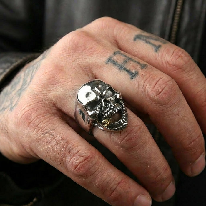 A model's hand wearing the sterling silver cigarette skull ring to demonstrate its bold, stylish look and comfortable fit.