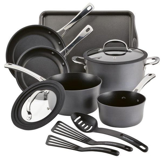 The Cook + Create Hard Anodized Nonstick Cookware Set includes black nonstick pots and pans, tempered glass lids, a spatula, and a baking sheet.