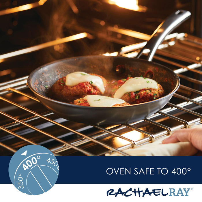 Cheese-topped meatballs sizzle in a Cook + Create Hard Anodized Nonstick Frying Pan tucked inside the oven. Its triple-layer nonstick surface ensures easy cooking and cleaning, making it a must-have for delicious meals.