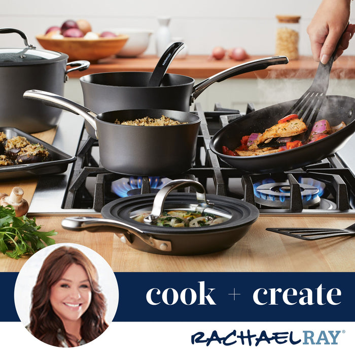 A variety of pots and pans, including a Cook + Create Hard Anodized Nonstick Frying Pan, sizzle with cooking food on the stove.