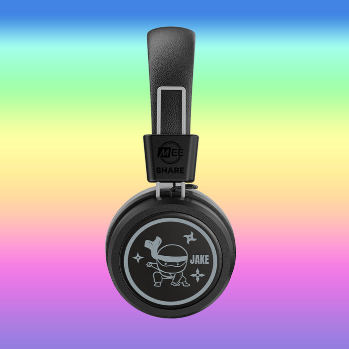 MEE audio KidJamz Share Bluetooth Wireless Headphones with a Ninja Turtle cartoon with the custom name "Jake" on the faceplate on a colorful background
