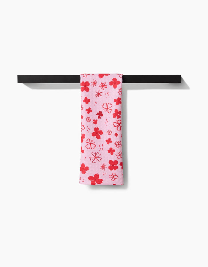 red floral towel hanging on black towel rack