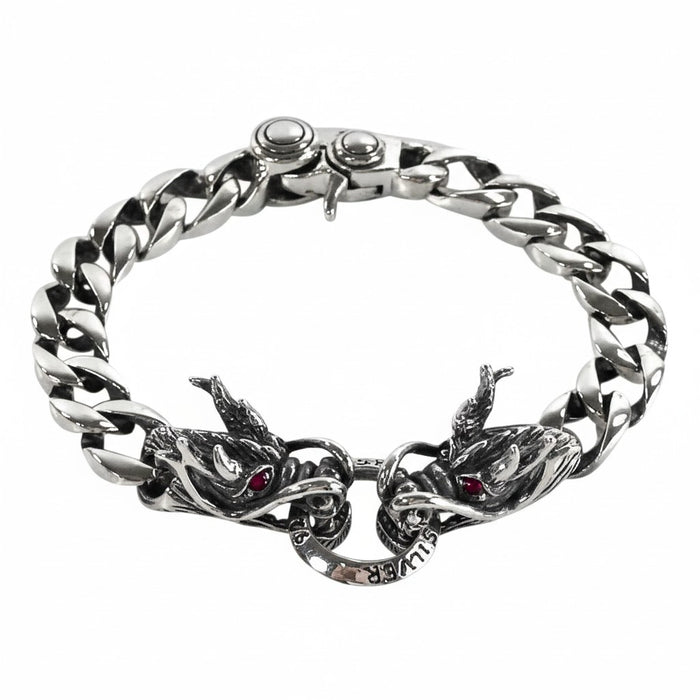 A men's solid sterling silver dragon bracelet with a 12mm Cuban link chain and double dragon head centerpiece with garnet eyes.