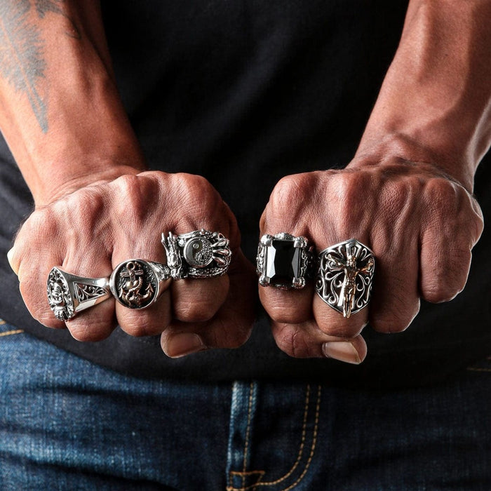 Man wearing multiple sterling silver statement rings including dragon yin yang design