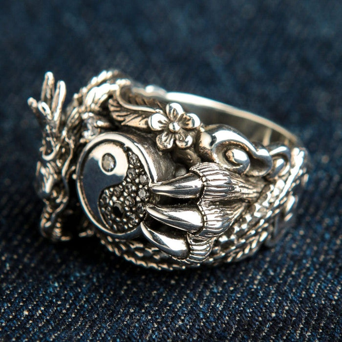 Side view of dragon yin yang ring showing cherry blossom details and dragon claw