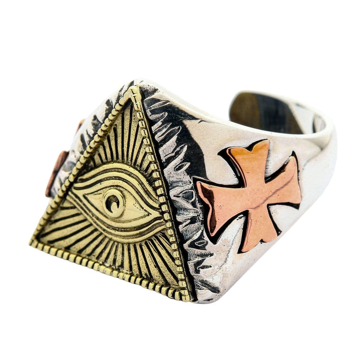 Angled view of silver pyramid ring with copper cross detail