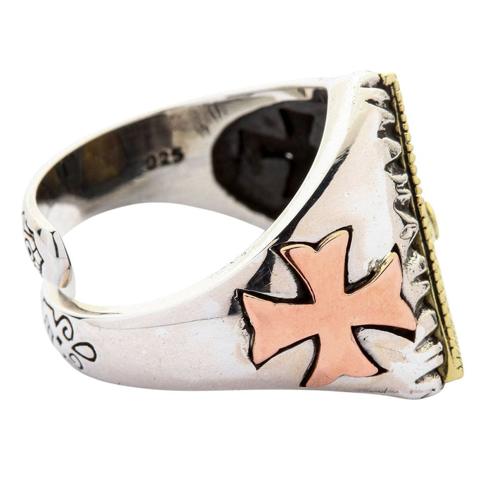 Detailed side view of copper cross on silver band