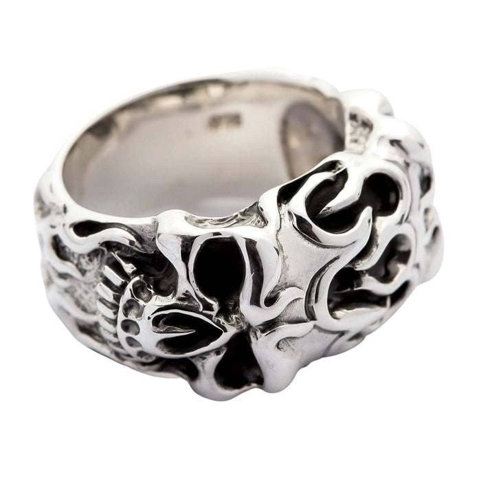 Side view of the sterling silver flame skull ring, with the carved tribal flames continuing down the side of the band.