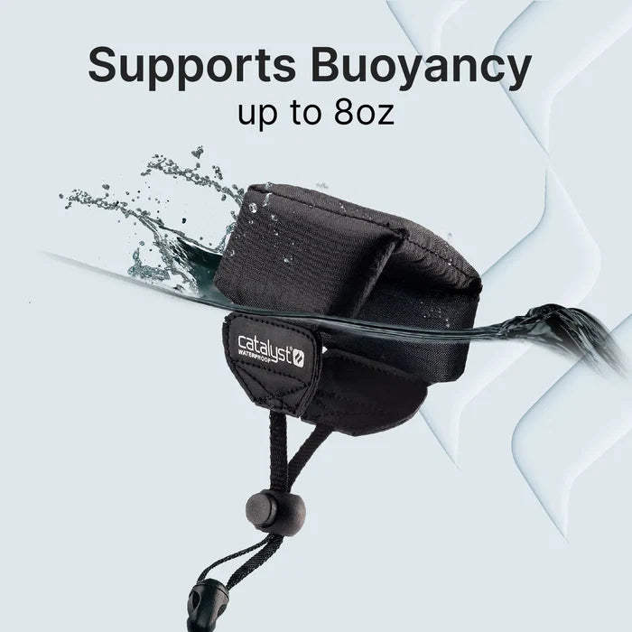A Catalyst Case US Floating Lanyard - Stealth Black is partially submerged in water with splashes. Above, the text reads "Supports Buoyancy up to 8oz." The backdrop features a light blue color with abstract water patterns on the right.