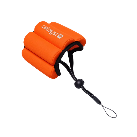 The Catalyst Case US Floating Wrist Lanyard is a bright orange foam strap with three curved sections, a black adjustable cord and toggle, and features the white ÃƒÂ¢Ã¢â€šÂ¬Ã…â€œcatalystÃƒÂ¢Ã¢â€šÂ¬Ã‚Â logo. ItÃƒÂ¢Ã¢â€šÂ¬Ã¢â€žÂ¢s designed to keep your devices afloat in water.