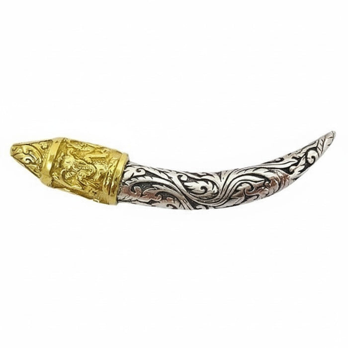 A side view of the two-tone Ganesha tusk pendant in 925 sterling silver and 14k gold-plated brass.