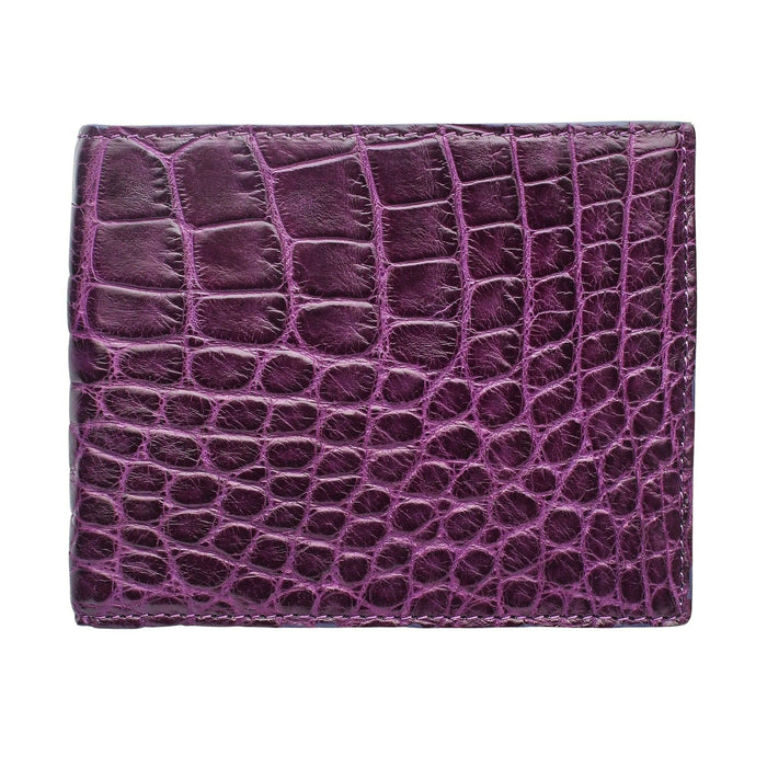 Deep violet crocodile belly-skin bifold wallet, shown closed against white, smooth central belly scales catching the light.