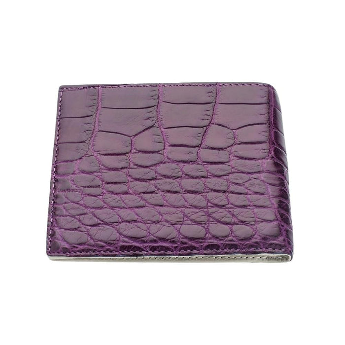 Front face of the closed violet bifold, with edge-stitched construction visible around the perimeter of the crocodile panel.