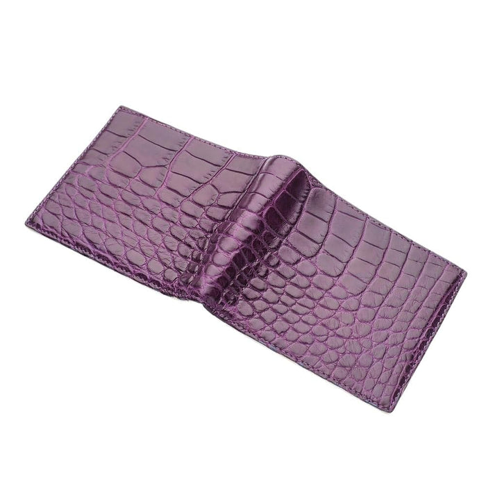 Opened purple crocodile wallet at an angle, showing the interior card pockets and lining laid out across both panels.