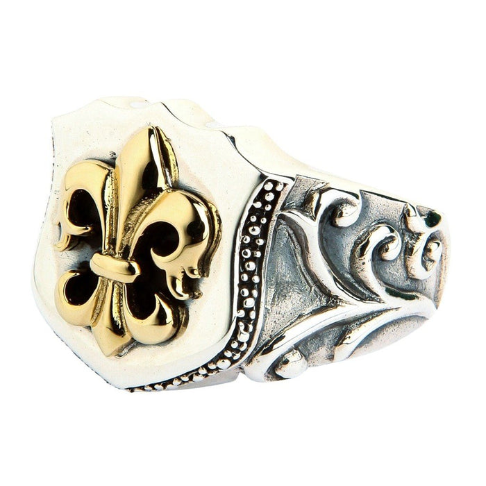 Three-quarter view of sterling silver shield ring highlighting baroque scrollwork on the band and raised gold fleur de lis on the face