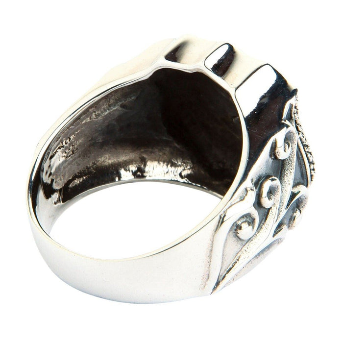 Rear underside view of sterling silver shield ring revealing smooth inner band and ornate baroque scroll relief on the shank