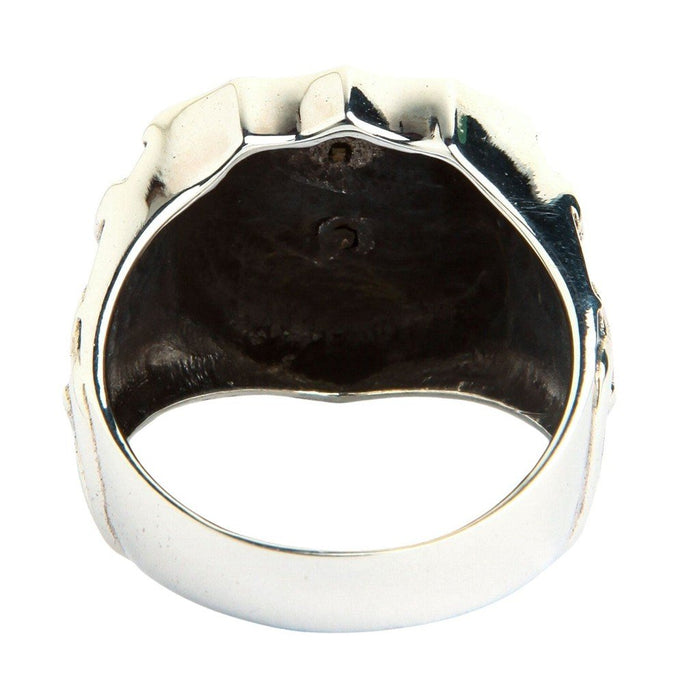 Back view into the hollow interior cavity of a sterling silver shield ring showing darkened oxidized inner surface and polished band edge