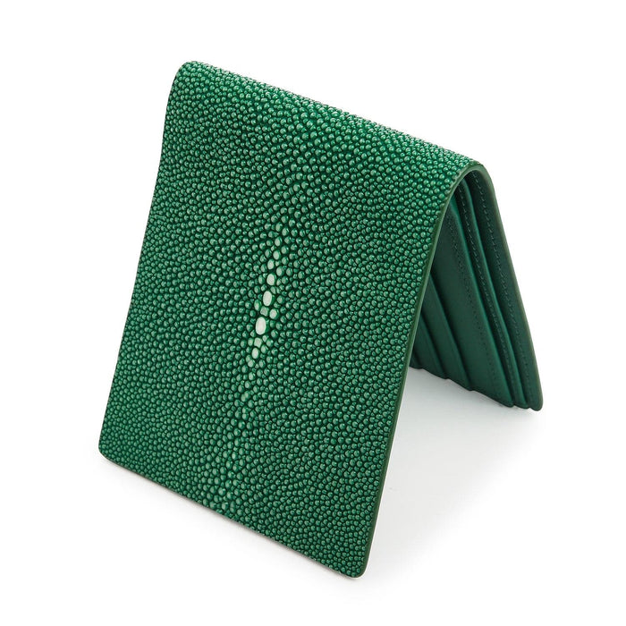 The handmade green leather wallet standing up to show its slim bifold profile.