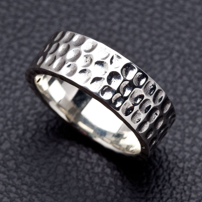 A bold, textured sterling silver band for men with a unique and masculine artisan-hammered design.
