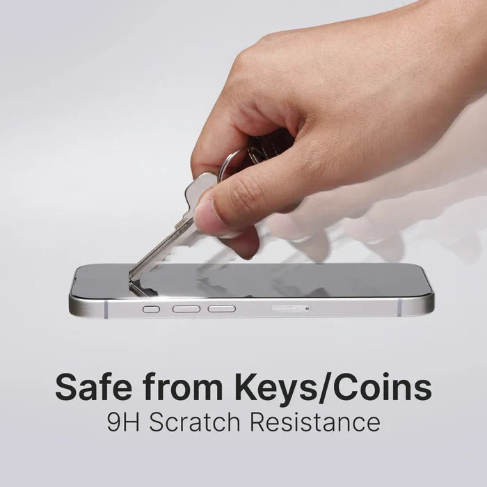 A hand scratches an iPhone 16 Pro with a key to show the Catalyst Case US Tempered Glass Screen Protector’s 9H scratch resistance. The screen stays flawless. Text: "Safe from Keys/Coins. 9H Scratch Resistance.