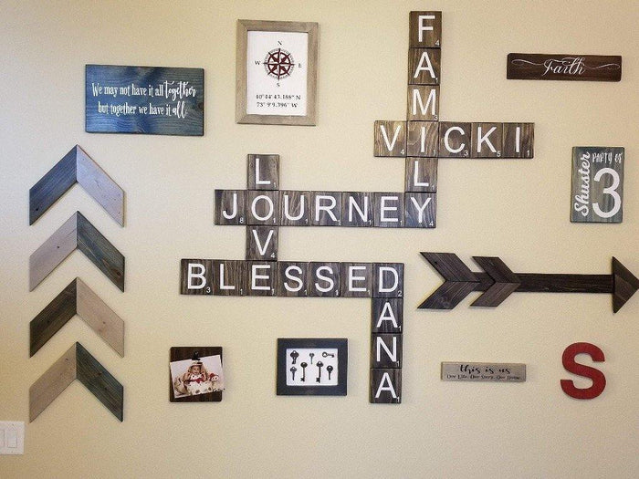 Rustic wall art with large Scrabble tiles spelling Live Laugh Love.