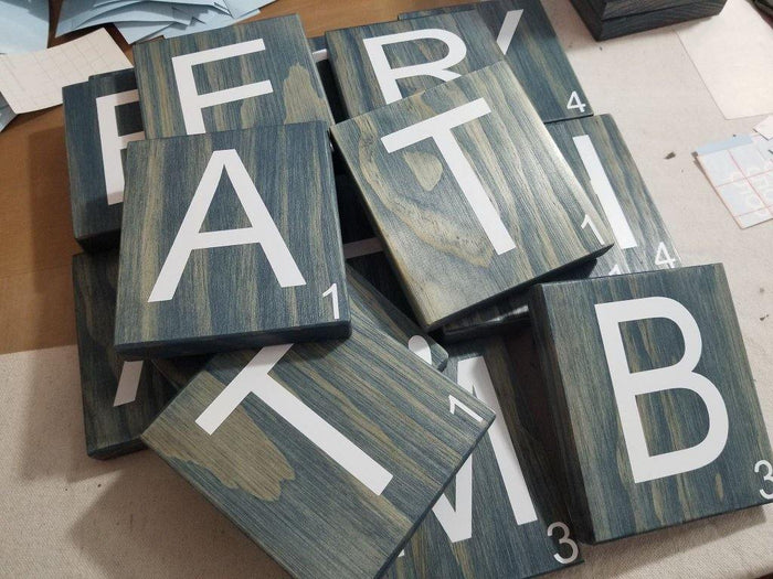 Oversized wooden Scrabble letters for home décor.
